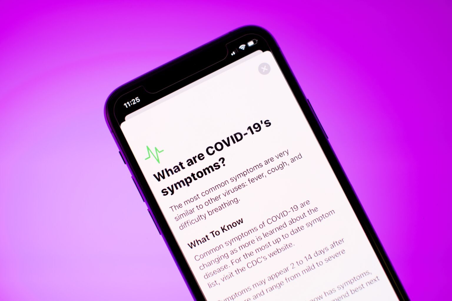 Understanding COVID-19 Symptoms in 2024: An Updated Guide a close up of a cell phone with the text what are covid - 19